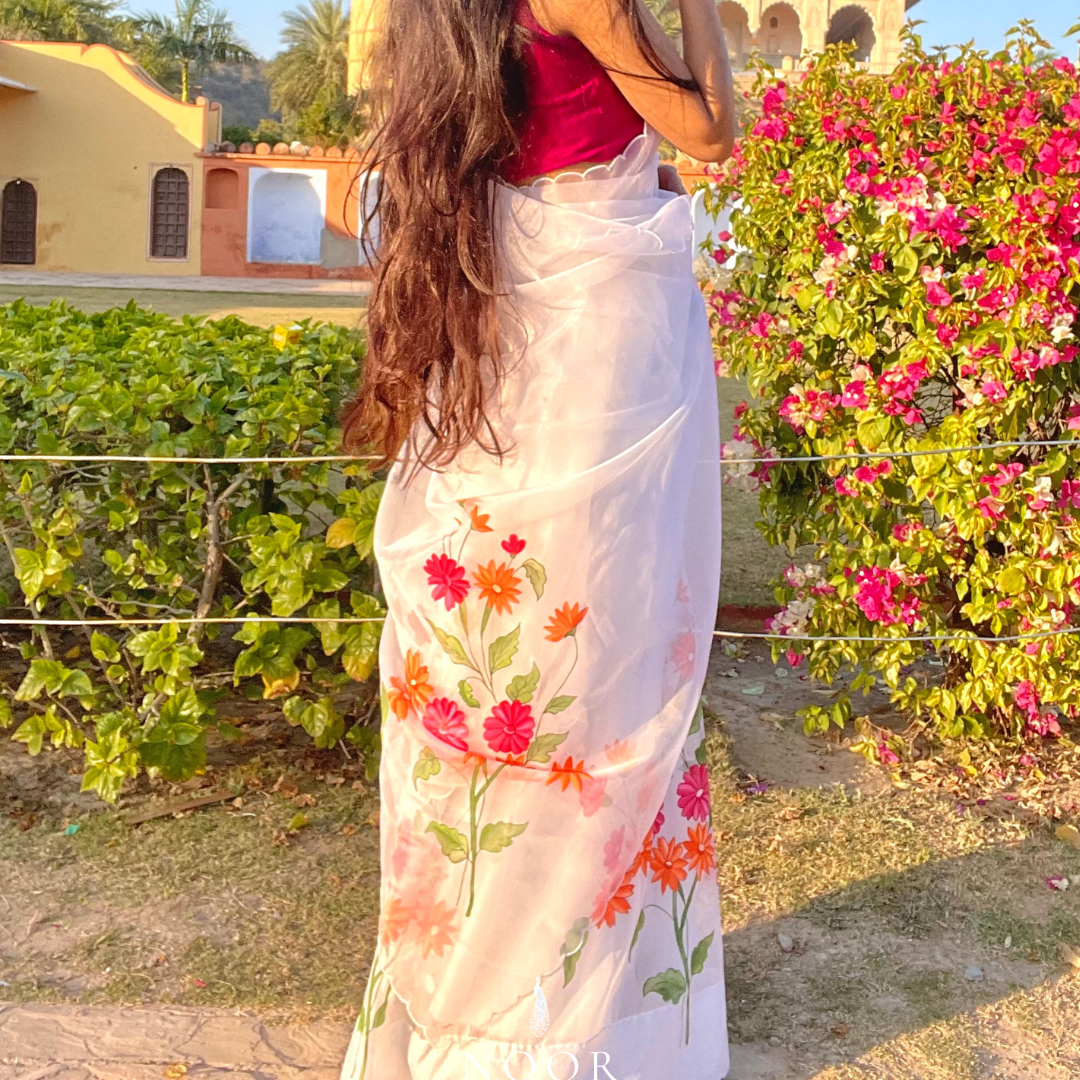 hand painted saree in pure organza silk by noor by hansa in white colour paired with a pure cotton blouse piece & scallop cutwork