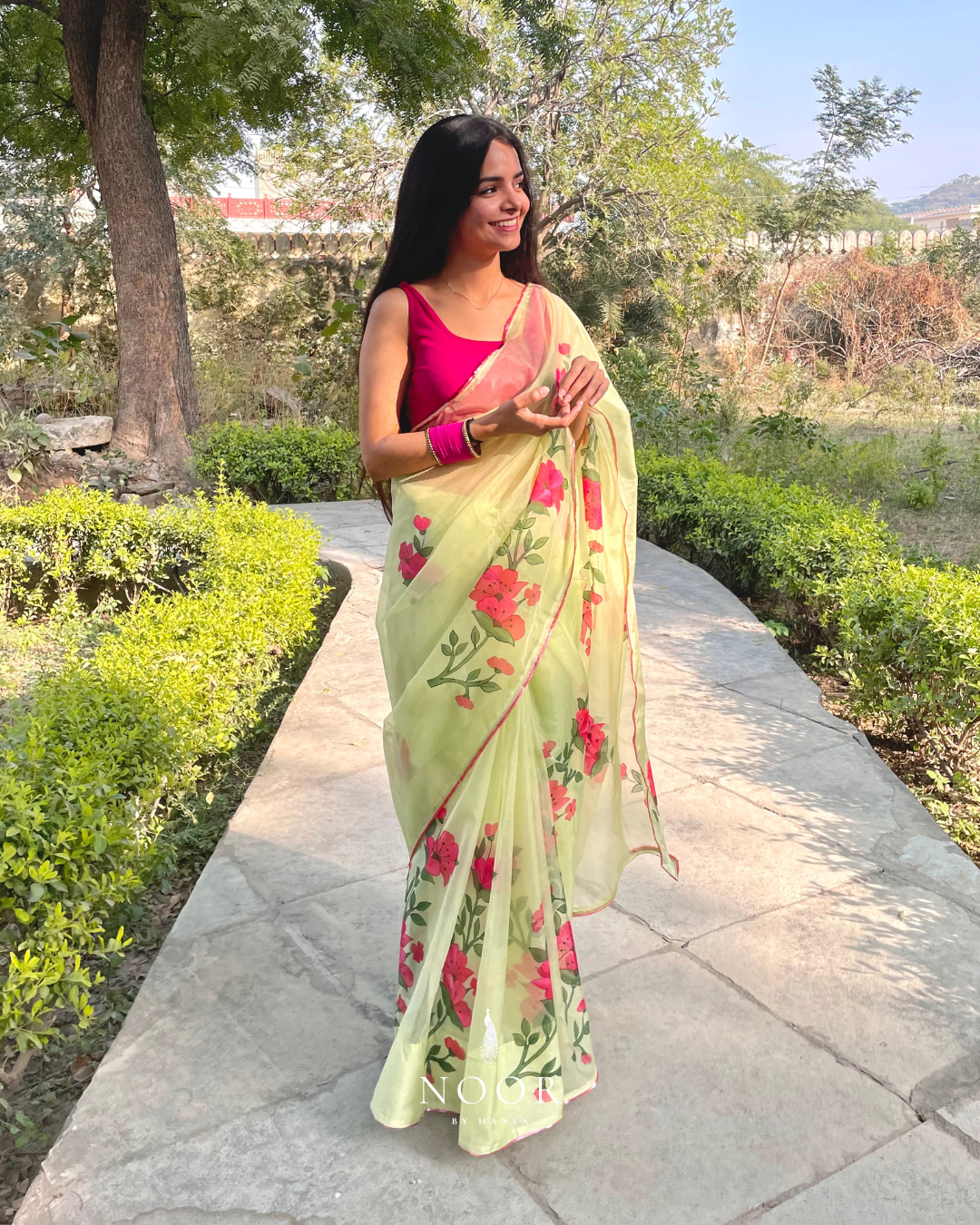 hand painted saree in pure organza silk by noor by hansa in pistachio green colour paired with a pure cotton blouse piece