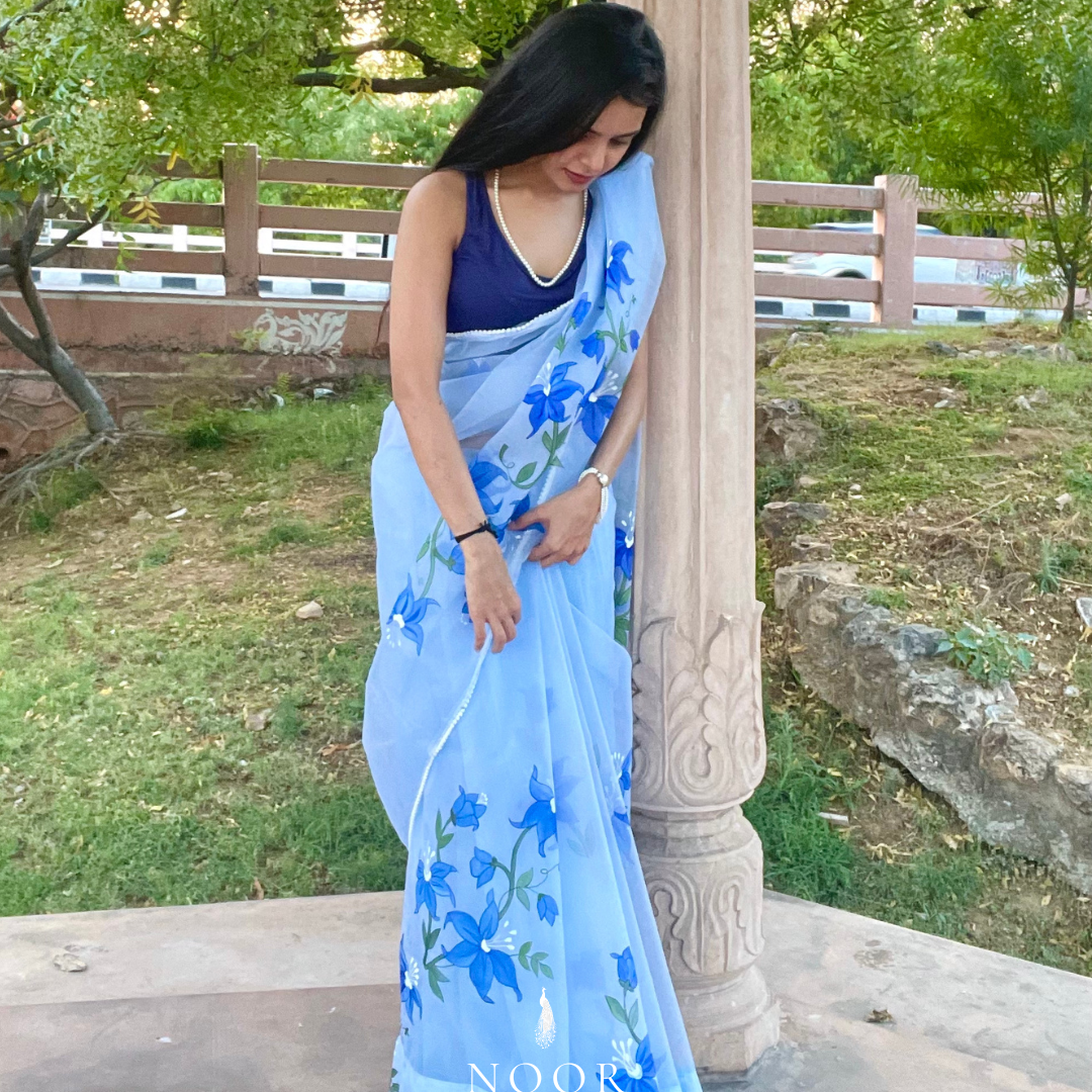 hand painted saree in pure organza silk by noor by hansa in sky blue colour paired with a blue blouse piece