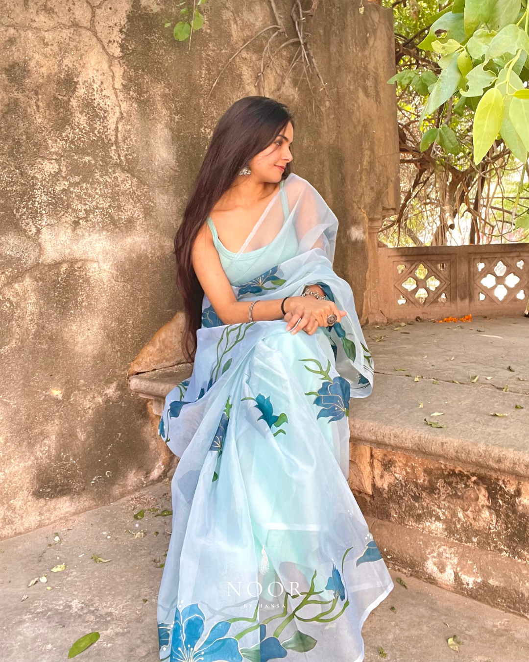 hand painted saree in pure organza silk by noor by hansa in teal colour paired with a pure cotton blouse piece, shells on the pallu