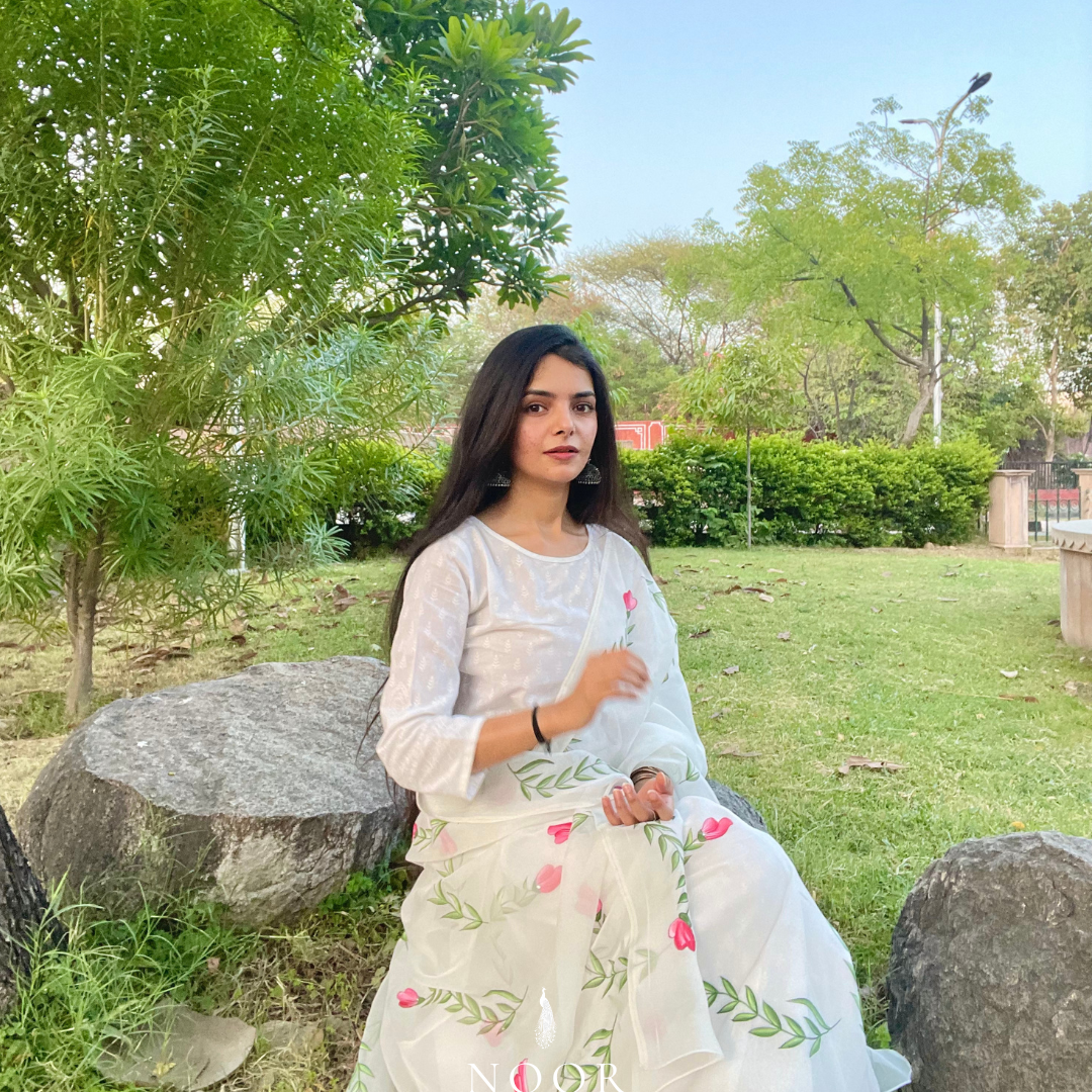 hand painted ivory 'jaituni' odhani in pure organza silk fabric with hand-painted motifs of leaves & pink tulips spread all over, embellished with studded stones. light and flowy, this makes for a perfect summer essential