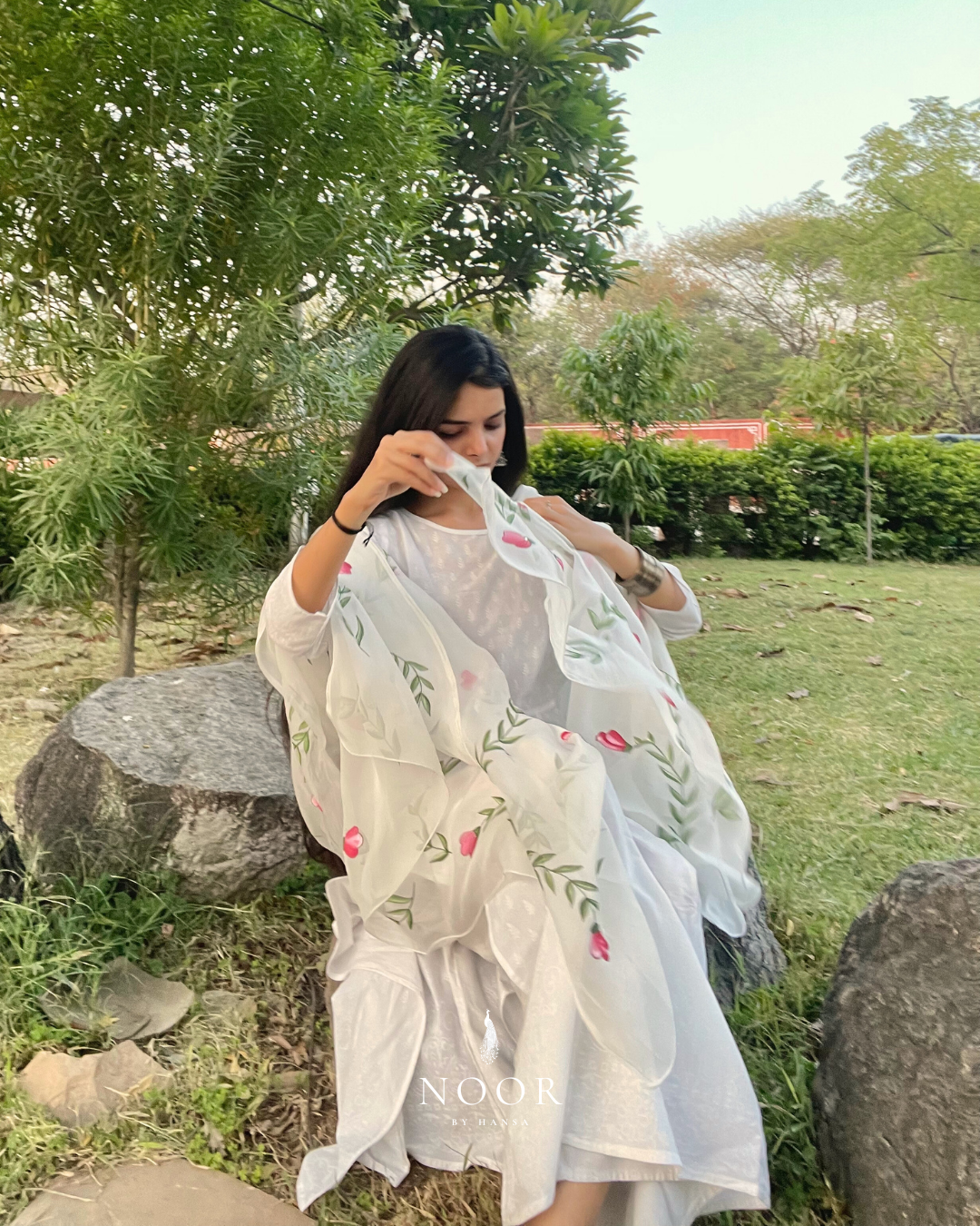 hand painted ivory 'jaituni' odhani in pure organza silk fabric with hand-painted motifs of leaves & pink tulips spread all over, embellished with studded stones. light and flowy, this makes for a perfect summer essential