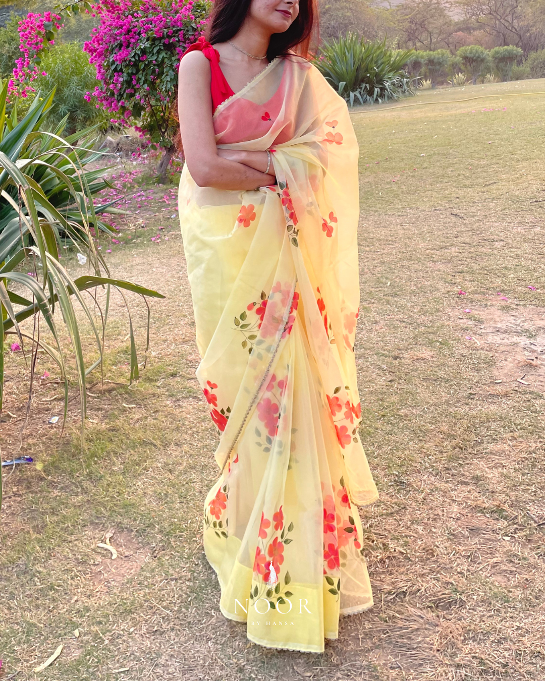 hand painted saree in pure organza silk by noor by hansa in yellow colour paired with a pure cotton blouse piece