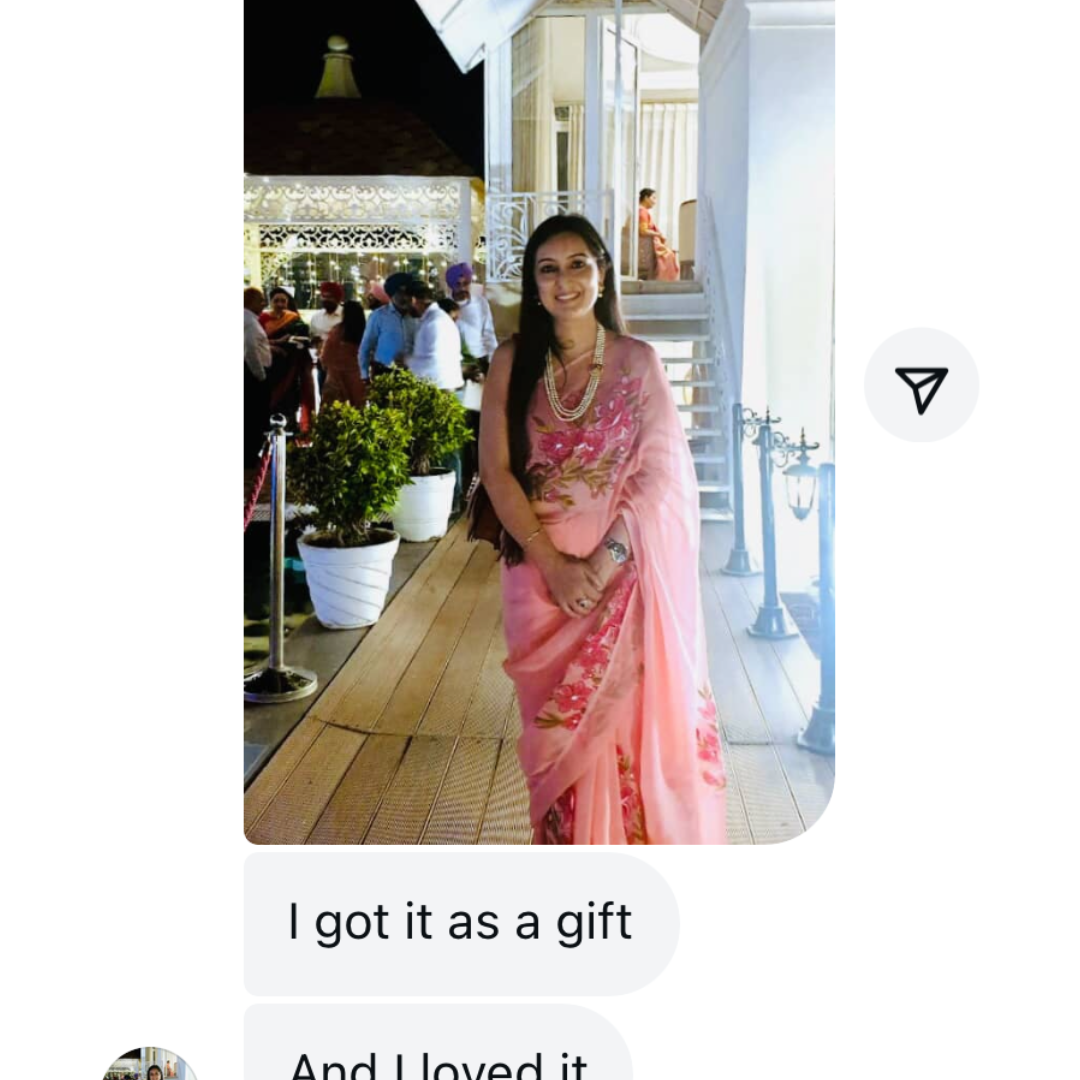 Woman in a pink saree standing outdoors with text indicating she received it as a gift and loved it.