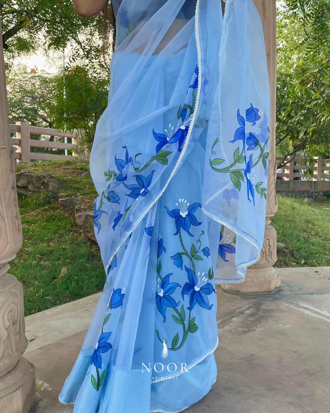 hand painted saree in pure organza silk by noor by hansa in sky blue colour paired with a blue blouse piece