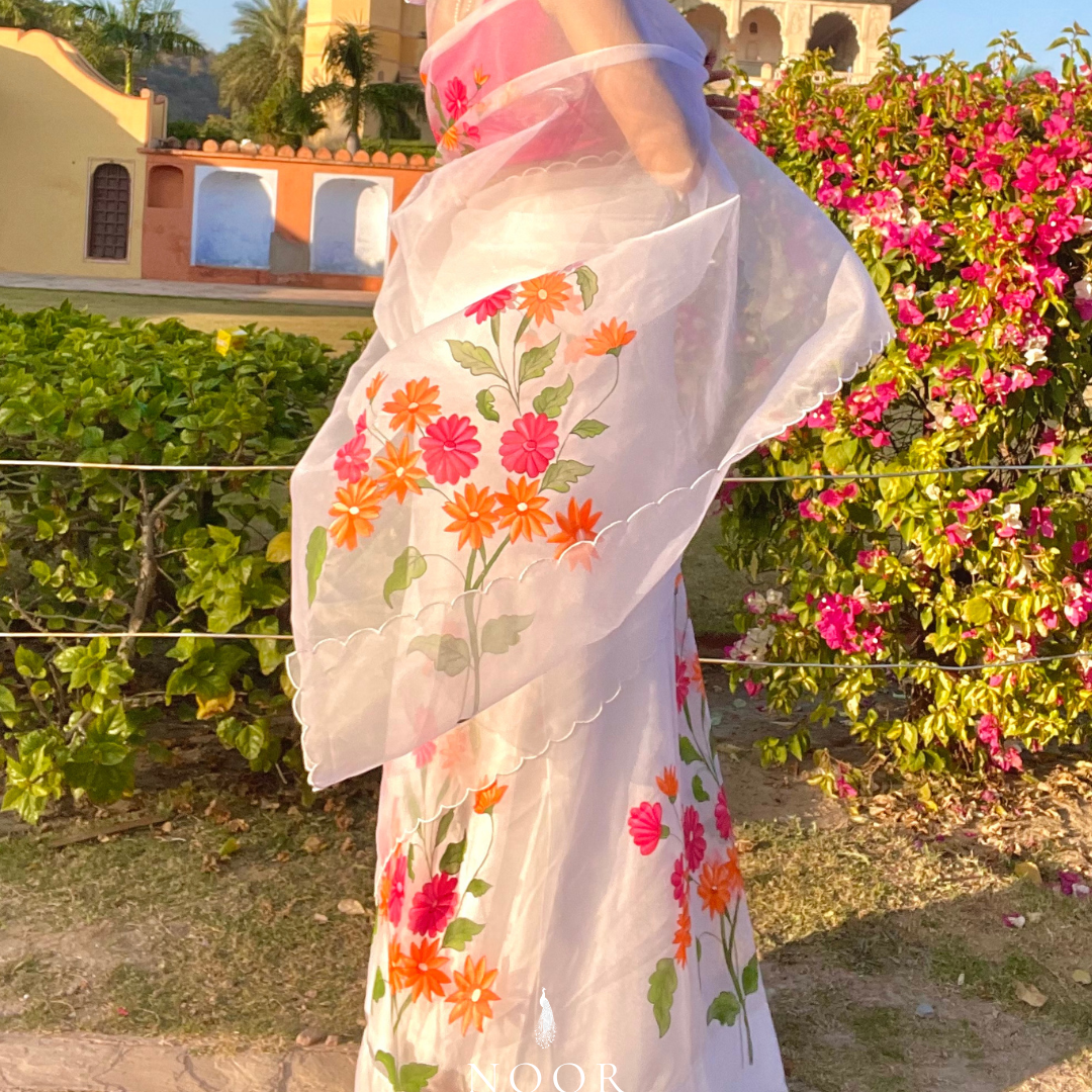 hand painted saree in pure organza silk by noor by hansa in white colour paired with a pure cotton blouse piece & scallop cutwork