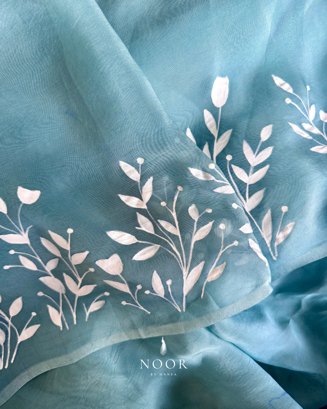 Teal blue sarees with white floral hand painted detailing.hand painted sarees
handpainted sarees
handpainted sari
hand painted saris
jaipur sarees
handcrafted saris
organza silk sarees
tissue sarees
tissue saris
organza silk saris