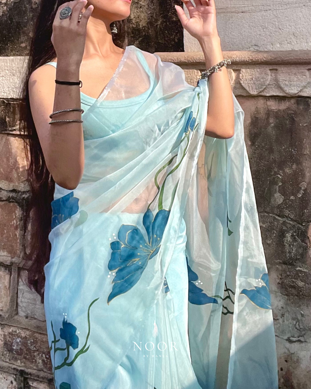 hand painted saree in pure organza silk by noor by hansa in teal colour paired with a pure cotton blouse piece, shells on the pallu