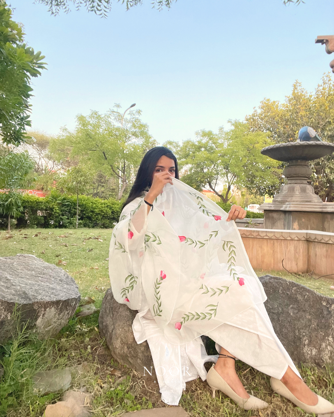 hand painted ivory 'jaituni' odhani in pure organza silk fabric with hand-painted motifs of leaves &amp; pink tulips spread all over, embellished with studded stones. light and flowy, this makes for a perfect summer essential