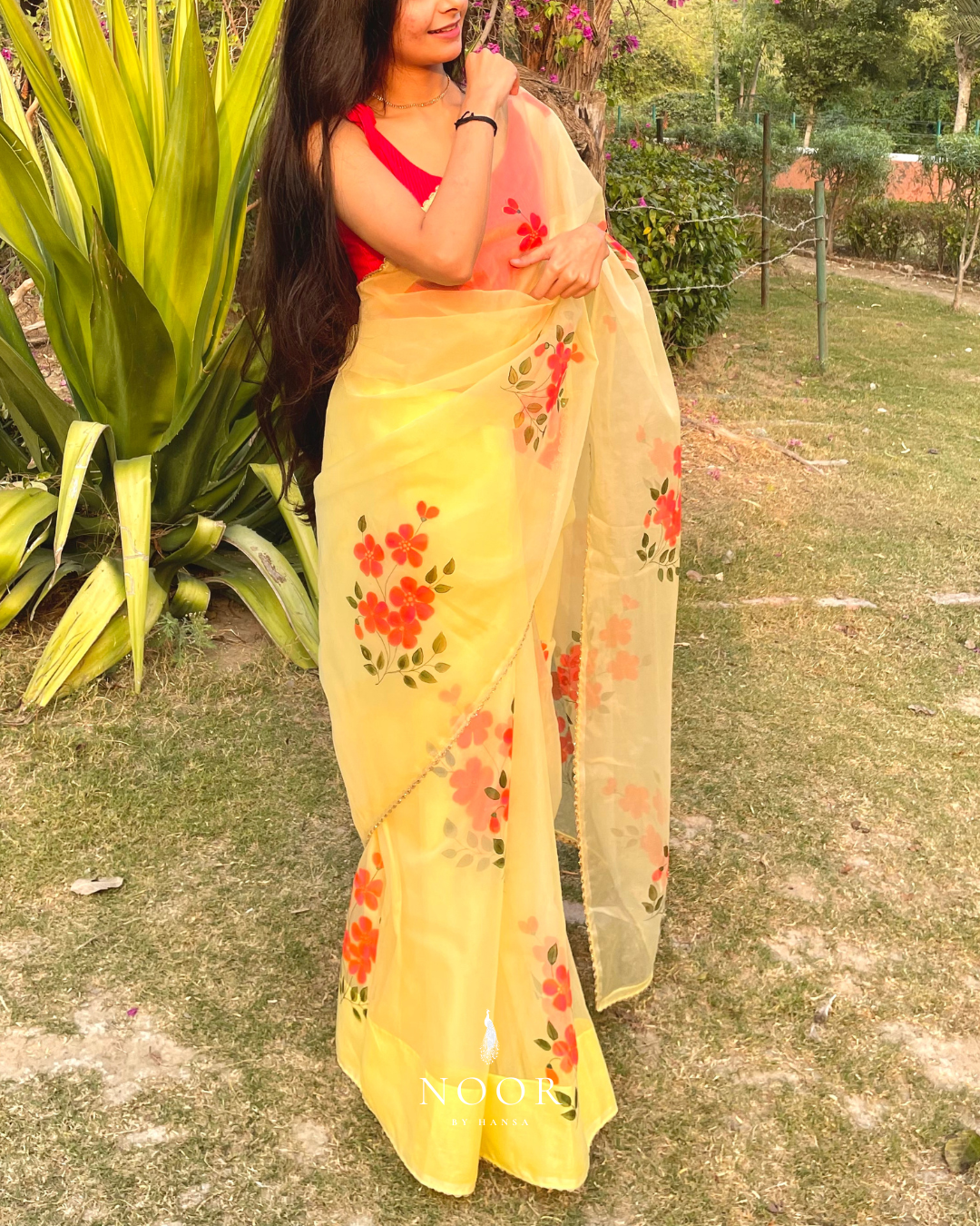 hand painted saree in pure organza silk by noor by hansa in yellow colour paired with a pure cotton blouse piece