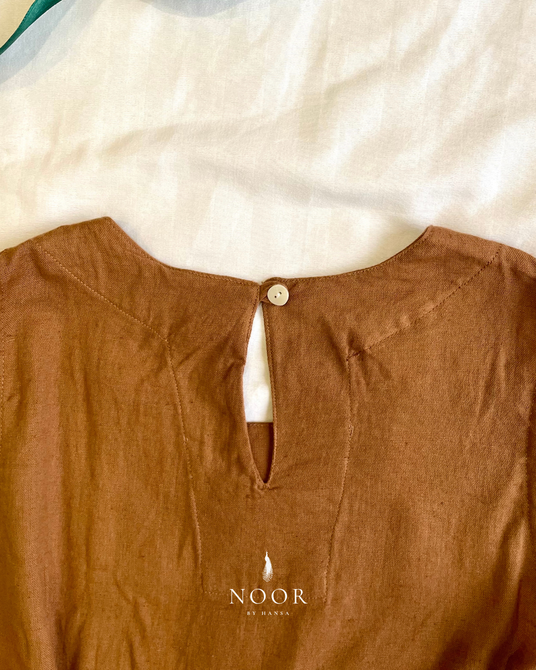 linen sleeveless kurtas brown ecru rose pink black white noor by hansa crafted from a luxe linen-cotton blend that feels as good as it looks. available in five vibrant colours, these would become your wardrobe staples